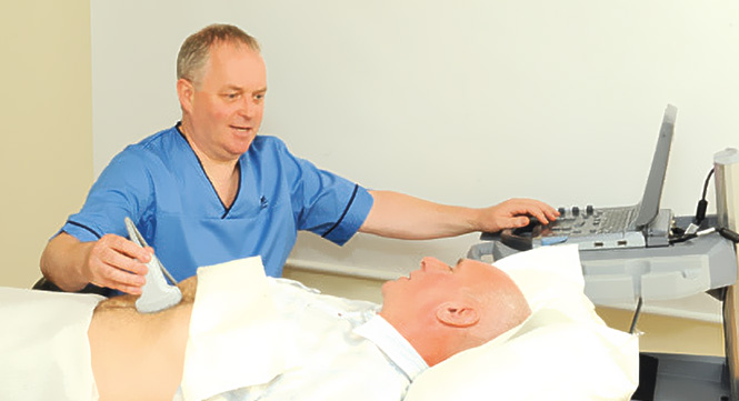 A nurse conducts an ultrasound test on an older man's abdomen