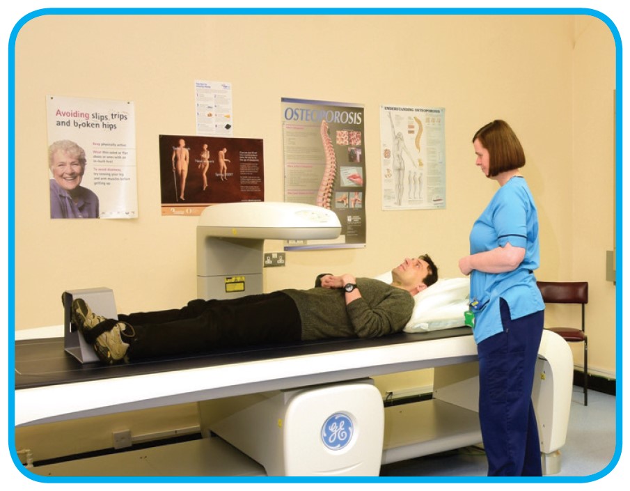 Radiographer And Patient With DXA Bone Scanner